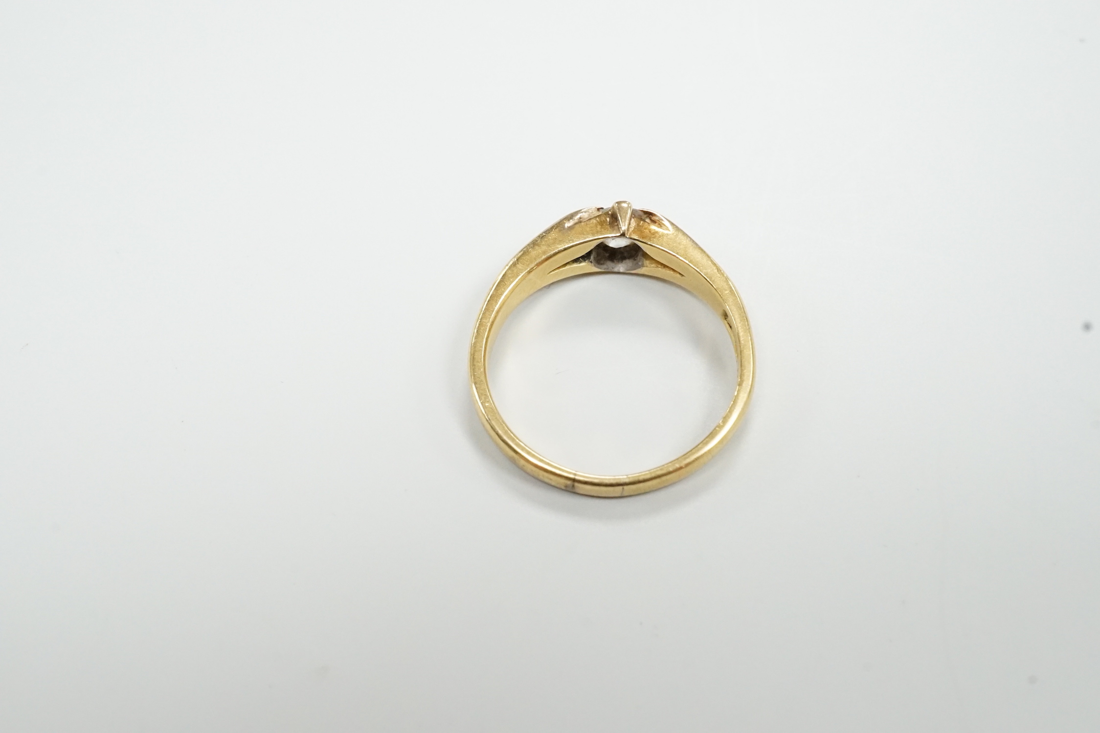 An 18ct gold and claw set solitaire diamond ring, size O, gross weight 3.9 grams.